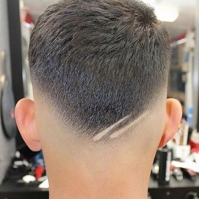 Clean mid-fade haircut with a hard part