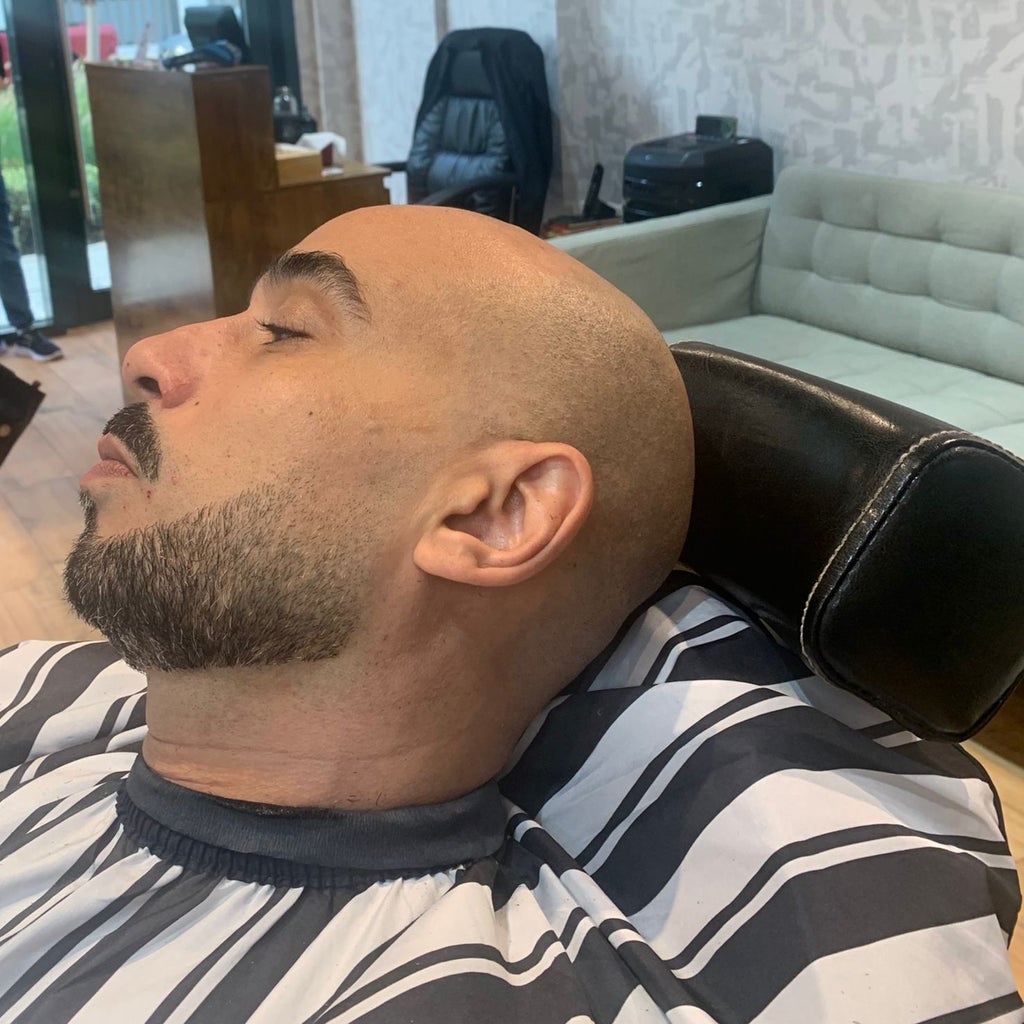 Client relaxing during a beard and shave service